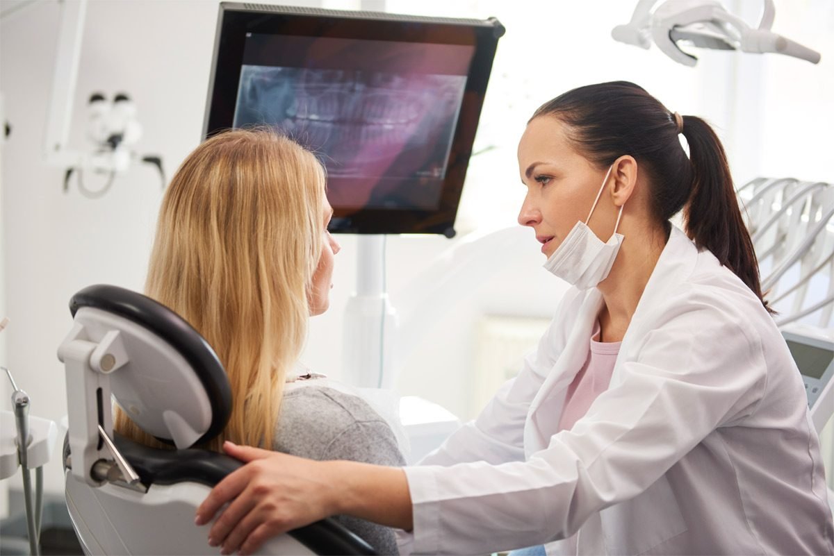 Dentist consulting with a patient about treatment