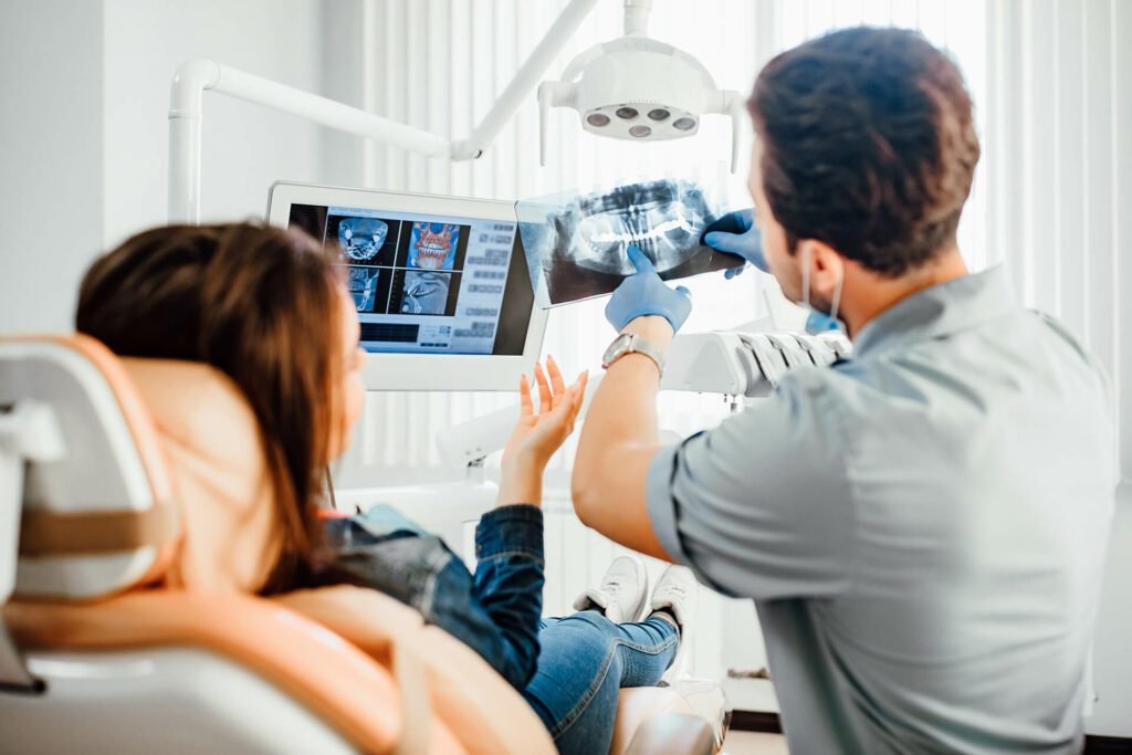 Dentist reviewing implant x-rays with a patient