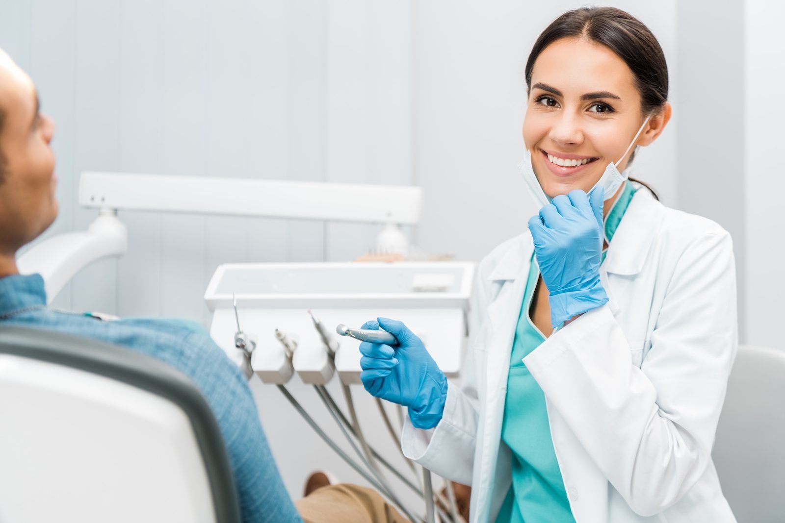Dentist smiling with a patient in a modern dental office