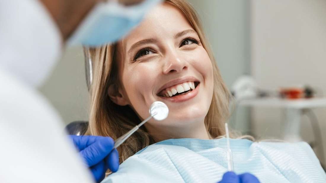 Happy patient in the dental chair after treatment